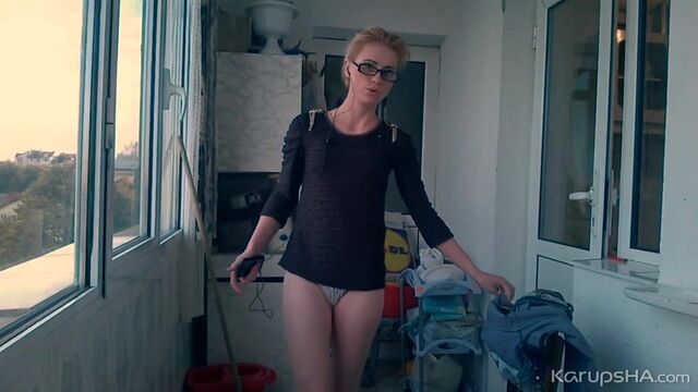 Sporty young chick Dani 2 gets naked on the balcony in a hot way