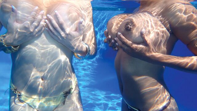Valory Irene shows off her massive natural tits in the outdoor pool