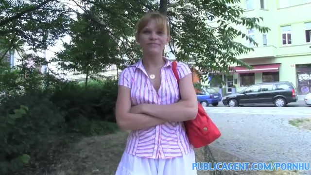 Baby Dream squats by brick wall with white skirt up fingering herself