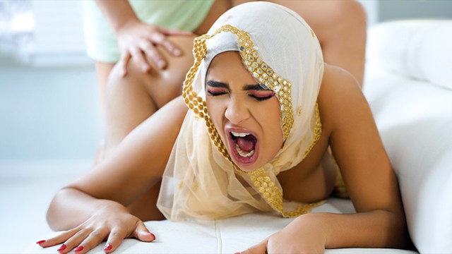 Babi Star in ornate gold tan hijab on all fours with floral thigh tattoo