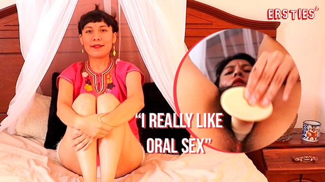 Anahi keeps the glove on while the dildo disappears into her full bush